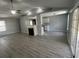 Spacious living room showing laminate floors, fireplace, and view into the kitchen area at 9888 Conifer Ln., Murrells Inlet, SC 29576