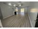 Open living room with vaulted ceilings, a fireplace, and sliding glass doors to the backyard at 9888 Conifer Ln., Murrells Inlet, SC 29576