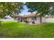 Spacious backyard featuring a charming brick patio, lush lawn, and mature trees at 1008 Plantation Dr., Surfside Beach, SC 29575