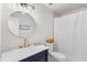 Bathroom featuring a stylish vanity with marble countertop, a round mirror, and modern fixtures at 1008 Plantation Dr., Surfside Beach, SC 29575