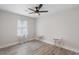 Bright bedroom featuring modern ceiling fan, neutral walls, and wood-look flooring at 1008 Plantation Dr., Surfside Beach, SC 29575