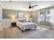 Stylish bedroom featuring paneled walls, ceiling fan, and natural light from dual windows at 1008 Plantation Dr., Surfside Beach, SC 29575