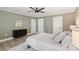 Bedroom with modern decor, neutral paint, sleek ceiling fan, and ample natural light at 1008 Plantation Dr., Surfside Beach, SC 29575