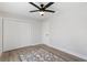 Bedroom boasts wood-look flooring, a ceiling fan, and a double-door closet at 1008 Plantation Dr., Surfside Beach, SC 29575