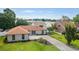 Scenic view of the front yard, landscaping, and neutral brick exterior in a quiet, residential neighborhood at 1008 Plantation Dr., Surfside Beach, SC 29575