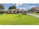 Beautifully landscaped front yard with lush green grass leading to a well-maintained single-story home at 1008 Plantation Dr., Surfside Beach, SC 29575