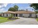 Charming single-story home with a well-manicured lawn and a neutral brick facade with black trim at 1008 Plantation Dr., Surfside Beach, SC 29575