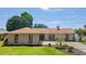 Inviting front exterior with a well-kept lawn, landscaping, and a charming neutral brick facade at 1008 Plantation Dr., Surfside Beach, SC 29575