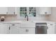 Bright kitchen featuring white cabinetry, stainless steel appliances, and a farmhouse sink at 1008 Plantation Dr., Surfside Beach, SC 29575