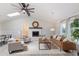 Bright and airy living room featuring high ceilings, modern furniture, and a cozy fireplace at 1008 Plantation Dr., Surfside Beach, SC 29575