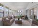 Sunroom filled with natural light, featuring wicker furniture and views of the outdoors at 1008 Plantation Dr., Surfside Beach, SC 29575