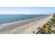 Amazing overhead view of the pristine beach with blue water, sand, palm trees and community pool at 10200 Beach Club Dr. # 16F, Myrtle Beach, SC 29572