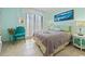 Bright bedroom featuring stylish decor, a comfortable bed, and access to natural light through louvered glass doors at 10200 Beach Club Dr. # 16F, Myrtle Beach, SC 29572