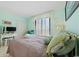 Serene bedroom with a full closet, decorative seascape art, and balcony access through louvered glass doors at 10200 Beach Club Dr. # 16F, Myrtle Beach, SC 29572