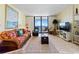 Cozy living room offers views of the ocean from the balcony accessible through sliding glass doors at 10200 Beach Club Dr. # 16F, Myrtle Beach, SC 29572