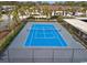 Overhead view of the community tennis court, with surrounding landscape and adjacent residential buildings at 10200 Beach Club Dr. # 16F, Myrtle Beach, SC 29572