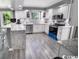 Bright kitchen with white cabinets, stainless steel appliances, and a spacious granite countertop island at 1150 Waterway Dr., Myrtle Beach, SC 29572