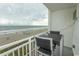 Balcony with ocean views and outdoor seating with a small table and two chairs at 1207 S Ocean Blvd. # 20403, Myrtle Beach, SC 29577