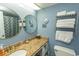 Bathroom featuring granite countertop, double mirrors, and towel rack at 1207 S Ocean Blvd. # 20403, Myrtle Beach, SC 29577