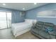 Bedroom with queen bed, loveseat, and ocean view at 1207 S Ocean Blvd. # 20403, Myrtle Beach, SC 29577
