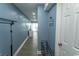 Hallway with blue walls leading to a bedroom with furniture in sight at 1207 S Ocean Blvd. # 20403, Myrtle Beach, SC 29577