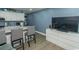 Modern kitchen with white cabinets, stainless steel appliances, and breakfast bar seating at 1207 S Ocean Blvd. # 20403, Myrtle Beach, SC 29577