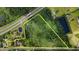 Aerial view reveals a large parcel of land ideal for development, surrounded by mature trees and bordering an highway at 1217 S Highway 501, Marion, SC 29571
