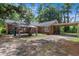 A spacious backyard includes a tented gathering space, and a covered carport adding functionality and charm at 1217 S Highway 501, Marion, SC 29571