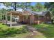 Property with a covered carport or storage area, complemented by a well-kept lawn and partial fencing at 1217 S Highway 501, Marion, SC 29571