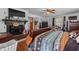 Bedroom boasts rustic charm with a fireplace, decorative mantle, wood flooring, and warm natural light at 1217 S Highway 501, Marion, SC 29571