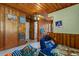 Vintage wood paneled bedroom with an adjoining bathroom, adding functionality and timeless appeal to the home at 1217 S Highway 501, Marion, SC 29571