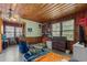 Rustic bedroom with wood paneled walls, ceiling fan, and natural light creates a cozy, traditional living space at 1217 S Highway 501, Marion, SC 29571