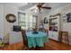 Charming dining room with wooden chairs, a vintage ceiling fan, and a bright tablecloth at 1217 S Highway 501, Marion, SC 29571