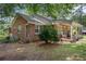 Brick home showcasing a side porch, manicured shrubbery and convenient access to the backyard and air conditioning unit at 1217 S Highway 501, Marion, SC 29571