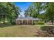 Charming brick home featuring a cozy front porch and a well-maintained lawn, nestled among mature trees at 1217 S Highway 501, Marion, SC 29571