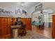 View from the workspace through the breakfast nook to the kitchen with wood paneling at 1217 S Highway 501, Marion, SC 29571