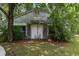 Exterior of an outbuilding with weathered siding and a large double-door entrance, surrounded by lush foliage at 1217 S Highway 501, Marion, SC 29571