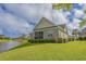 Well-maintained backyard with a screened porch, lush greenery, and a view of the lake at 1323 Ashboro Ct., Myrtle Beach, SC 29579