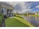 Expansive backyard with lush green lawn and tranquil pond views, perfect for relaxation at 1323 Ashboro Ct., Myrtle Beach, SC 29579