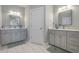 Bathroom with double vanity, marble countertops, mirrors, and tile flooring at 1323 Ashboro Ct., Myrtle Beach, SC 29579