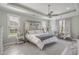 Bright bedroom featuring a ceiling fan, decorative doors, and multiple windows at 1323 Ashboro Ct., Myrtle Beach, SC 29579