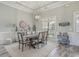 Dining room with modern chandelier, wainscoting and views of the landscaped yard at 1323 Ashboro Ct., Myrtle Beach, SC 29579