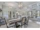 Dining room open to the living room features a modern chandelier and wood-look flooring at 1323 Ashboro Ct., Myrtle Beach, SC 29579