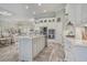 Open kitchen featuring an island with seating, stainless appliances, and white cabinetry at 1323 Ashboro Ct., Myrtle Beach, SC 29579