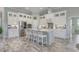 Bright kitchen featuring an island with seating, stainless appliances, and tile backsplash at 1323 Ashboro Ct., Myrtle Beach, SC 29579