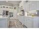 Elegant kitchen with white cabinetry, stainless steel appliances, and stylish tile backsplash at 1323 Ashboro Ct., Myrtle Beach, SC 29579
