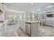 Open-concept kitchen island with marble countertops and stainless dishwasher connects to the living spaces at 1323 Ashboro Ct., Myrtle Beach, SC 29579