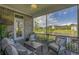 Relaxing screened porch overlooking a serene pond with comfortable seating and water views at 1323 Ashboro Ct., Myrtle Beach, SC 29579