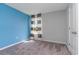 Modern bedroom featuring blue accent wall, natural light, and minimalist decor at 1429 Nokota Dr., Conway, SC 29526