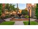 Picturesque courtyard featuring a tiered fountain, manicured shrubs, and a brick arched doorway at 1429 Nokota Dr., Conway, SC 29526